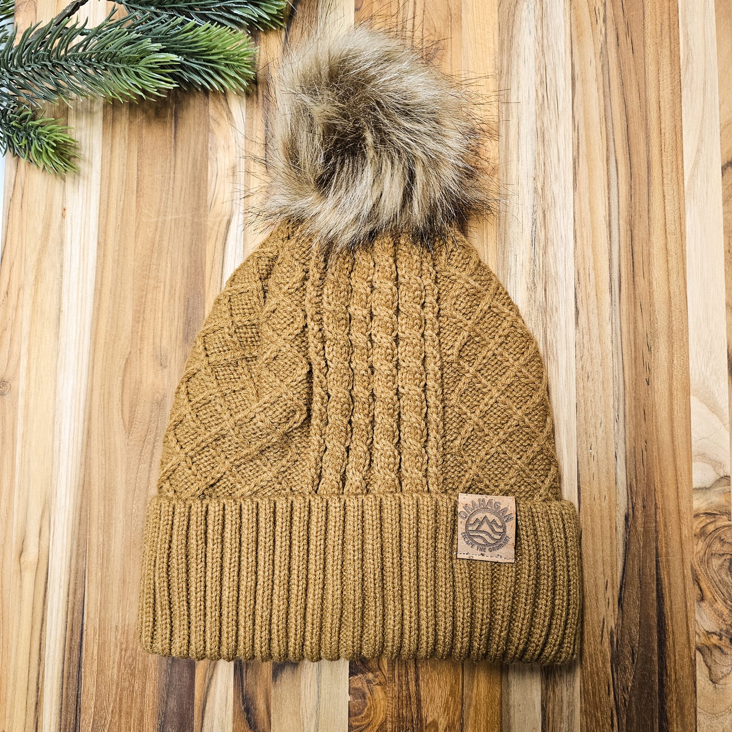 Okanagan Wave Cable Knit Toque with Faux Fur Pom and Cork Patch - Camel