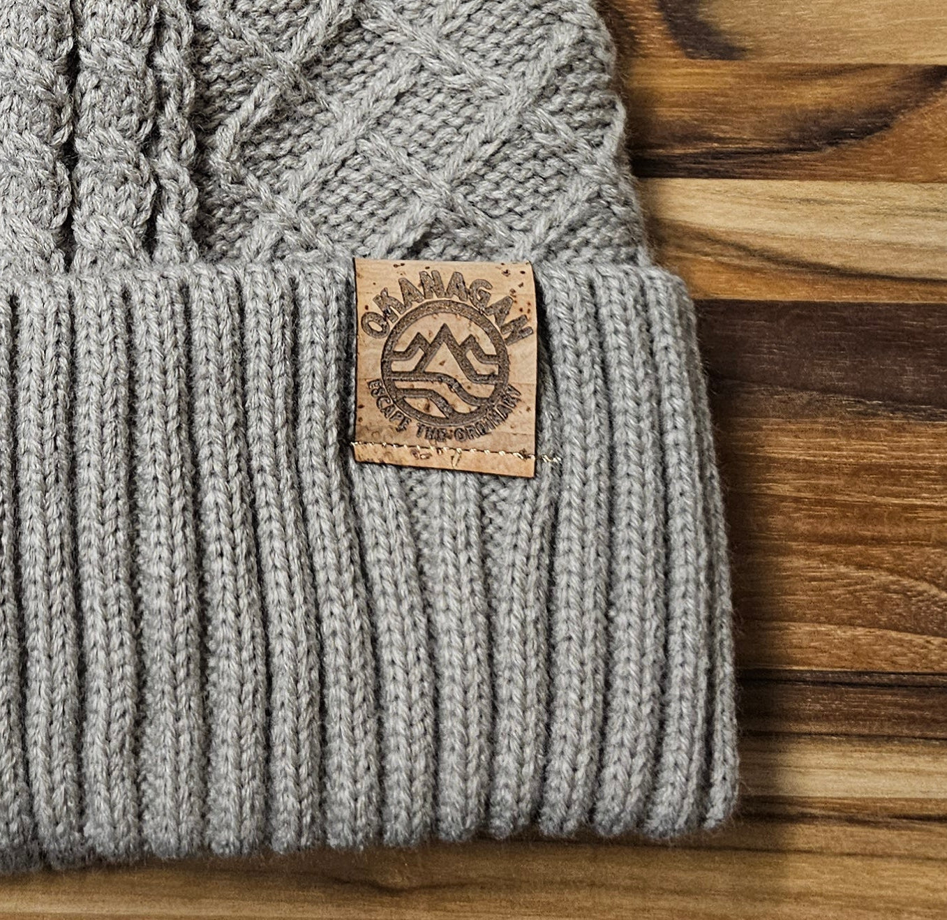 Okanagan Wave Cable Knit Toque in Oatmeal with Faux Fur Pom and Cork Patch